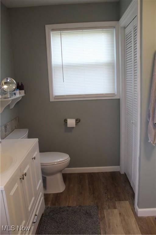 230 Rivercrest Dr, Coshocton, OH 43812 - bathroom featuring a closet, wood finished floors, toilet, vanity, and baseboards