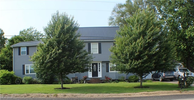 230 Rivercrest Dr, Coshocton, OH 43812 - view of property hidden behind natural elements featuring entry steps, a front yard, and metal roof