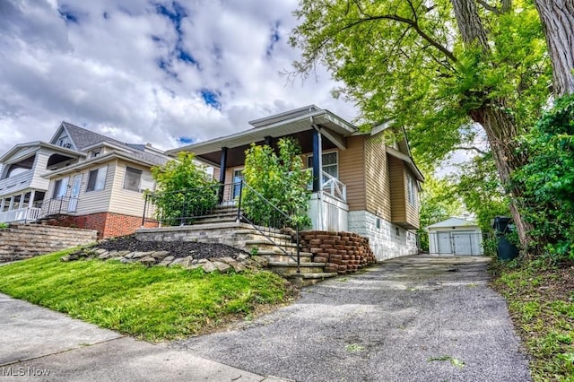 8208 Vista Ave, Garfield Heights, OH 44125 - view of front of property featuring stairway, an outbuilding, a porch, and a detached garage