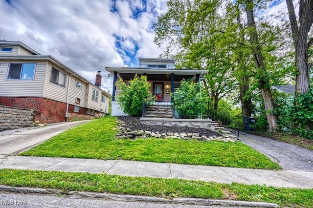 8208 Vista Ave, Garfield Heights, OH 44125 - view of front of property with a porch and a front lawn