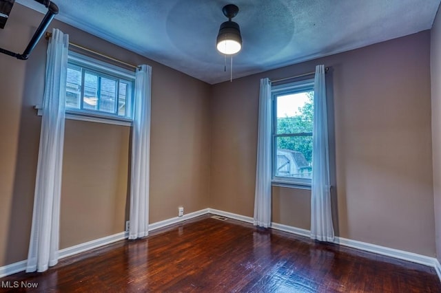 8208 Vista Ave, Garfield Heights, OH 44125 - empty room with wood-type flooring, baseboards, healthy amount of natural light, a textured ceiling, and ceiling fan