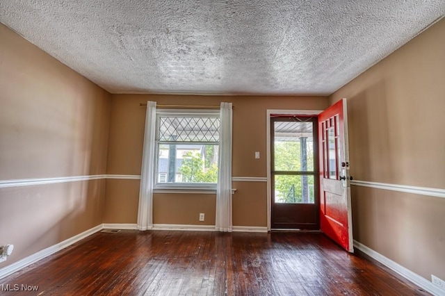 8208 Vista Ave, Garfield Heights, OH 44125 - foyer with hardwood / wood-style flooring, baseboards, and a textured ceiling