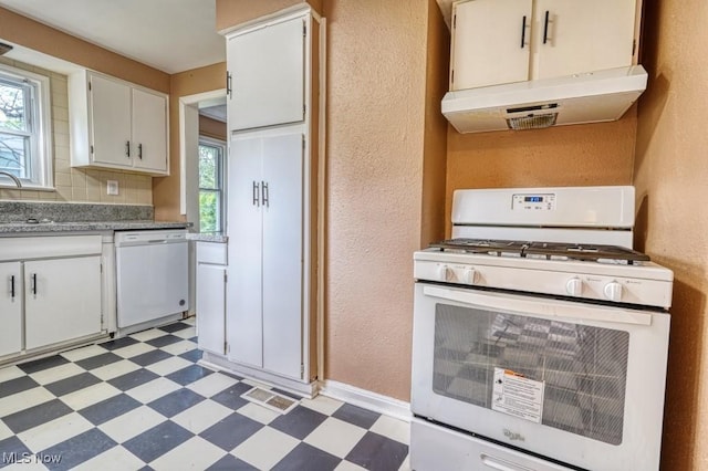 8208 Vista Ave, Garfield Heights, OH 44125 - kitchen with white appliances, light floors, under cabinet range hood, plenty of natural light, and a textured wall