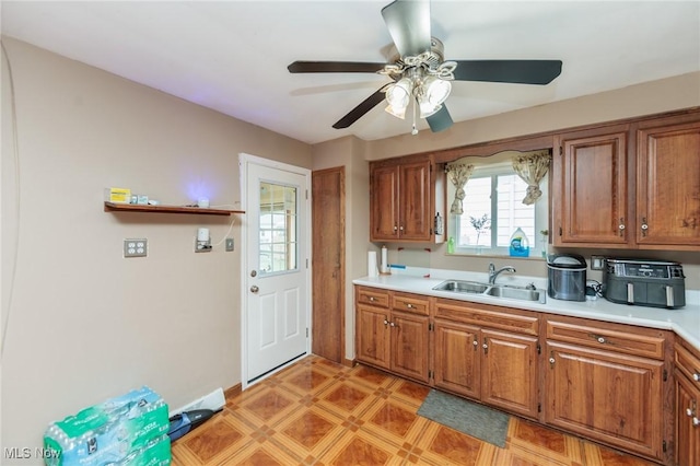 29431 Fairway Blvd, Willowick, OH 44095 - kitchen with light countertops, brown cabinetry, and ceiling fan