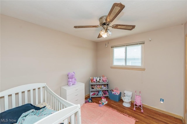 29431 Fairway Blvd, Willowick, OH 44095 - bedroom with wood finished floors, a ceiling fan, and a crib