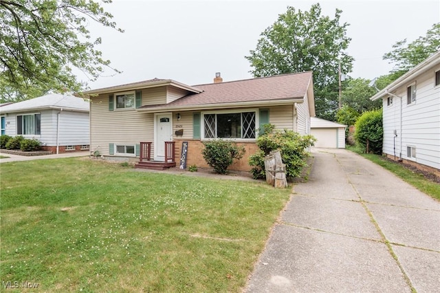 29431 Fairway Blvd, Willowick, OH 44095 - split level home featuring a front yard, an outdoor structure, a chimney, and a detached garage