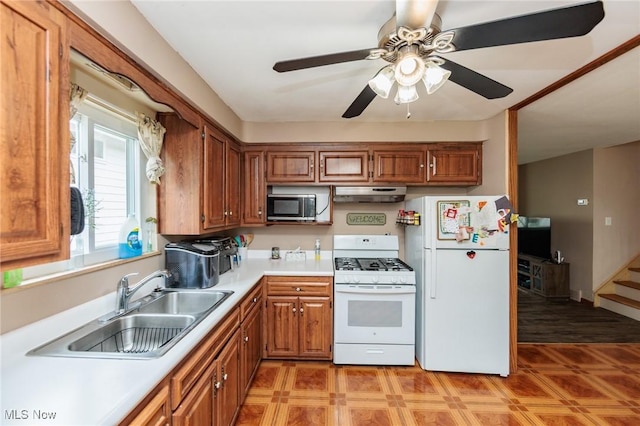 29431 Fairway Blvd, Willowick, OH 44095 - kitchen featuring white appliances, under cabinet range hood, and brown cabinets