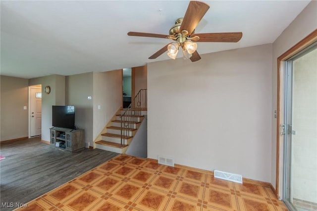 29431 Fairway Blvd, Willowick, OH 44095 - unfurnished living room with ceiling fan, stairs, and wood finished floors