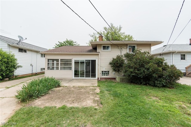 29431 Fairway Blvd, Willowick, OH 44095 - rear view of house featuring a chimney, a lawn, and a patio