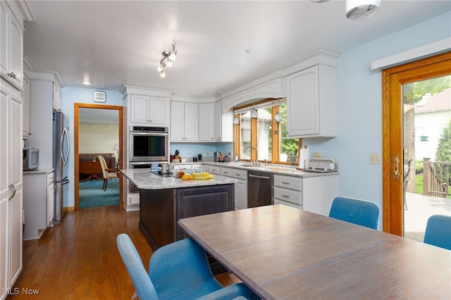118 Steeplechase Ln, Munroe Falls, OH 44262 - kitchen with stainless steel appliances, white cabinets, a kitchen island, dark wood-style flooring, and a sink
