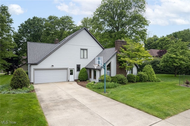 118 Steeplechase Ln, Munroe Falls, OH 44262 - view of front facade with a chimney, a shingled roof, a garage, concrete driveway, and a front lawn