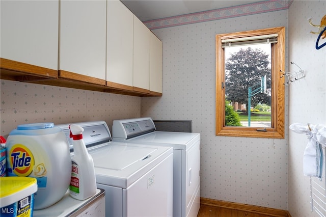 118 Steeplechase Ln, Munroe Falls, OH 44262 - laundry area with cabinet space, wallpapered walls, separate washer and dryer, baseboards, and wood finished floors