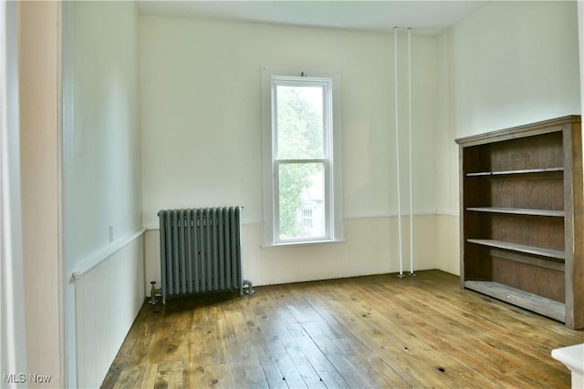 8273 Warren Meadville Rd, Kinsman, OH 44428 - spare room with radiator heating unit and hardwood / wood-style flooring