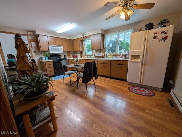 46340 Township Rd Unit 1208, Coshocton, OH 43812 - kitchen with white appliances, light countertops, light wood-style floors, brown cabinets, and a ceiling fan