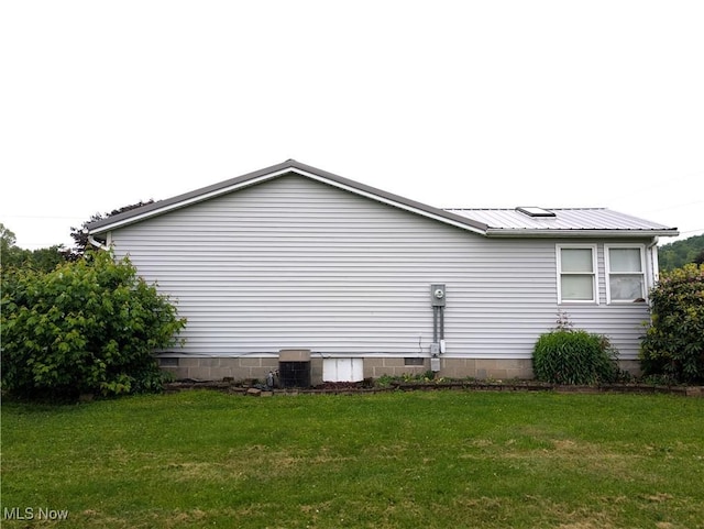 46340 Township Rd Unit 1208, Coshocton, OH 43812 - view of property exterior featuring a lawn, metal roof, and crawl space