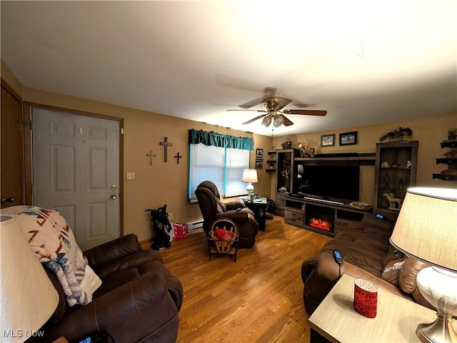 46340 Township Rd Unit 1208, Coshocton, OH 43812 - living area with wood finished floors, ceiling fan, and a baseboard heating unit