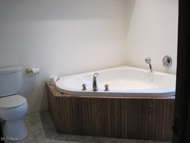 2710 W River Rd N, Elyria, OH 44035 - bathroom featuring a garden tub, toilet, and tile patterned floors