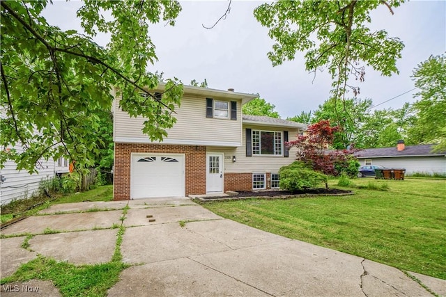 1105 E Blvd, Aurora, OH 44202 - split level home featuring an attached garage, brick siding, concrete driveway, and a front lawn