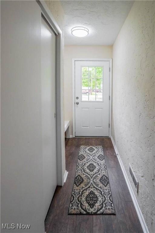 1105 E Blvd, Aurora, OH 44202 - doorway to outside featuring wood finished floors and a textured wall
