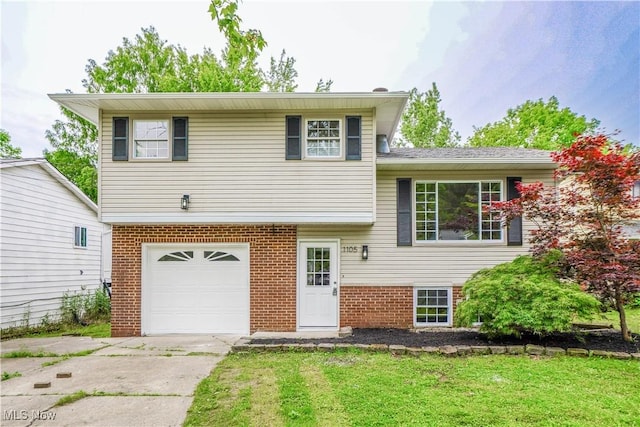 1105 E Blvd, Aurora, OH 44202 - split level home with a garage, brick siding, driveway, and a front yard