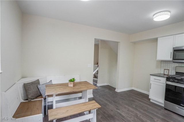 1105 E Blvd, Aurora, OH 44202 - dining area featuring stairway, dark wood-style floors, and baseboards