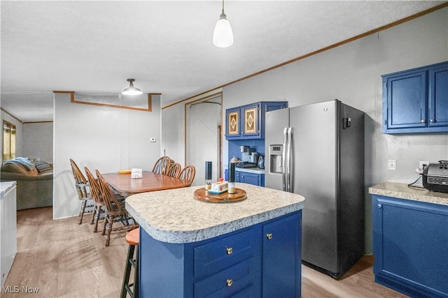 3764 US Highway 224 E Lot 92, Greenwich, OH 44837 - kitchen with blue cabinetry, stainless steel refrigerator with ice dispenser, light wood-style floors, light countertops, and ornamental molding