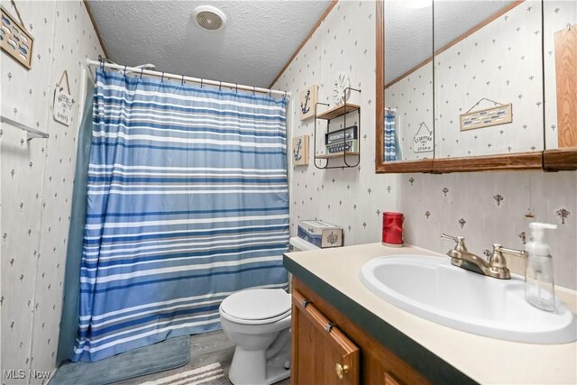 3764 US Highway 224 E Lot 92, Greenwich, OH 44837 - bathroom featuring wallpapered walls, a textured ceiling, vanity, and toilet