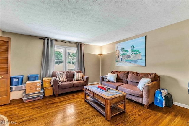 868 King George Blvd, South Euclid, OH 44121 - living room featuring wood finished floors, a textured ceiling, and baseboards