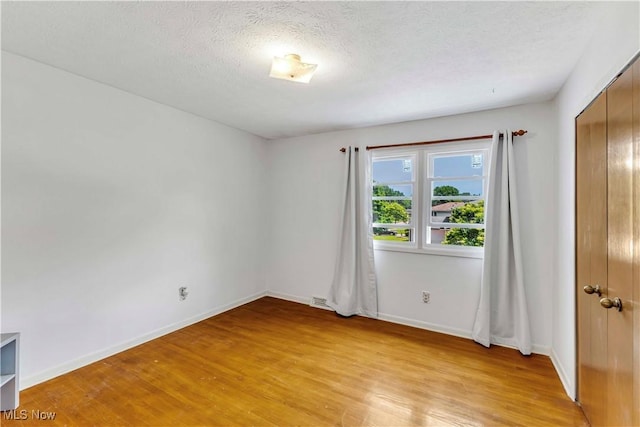 868 King George Blvd, South Euclid, OH 44121 - empty room with light wood-style floors, baseboards, and a textured ceiling