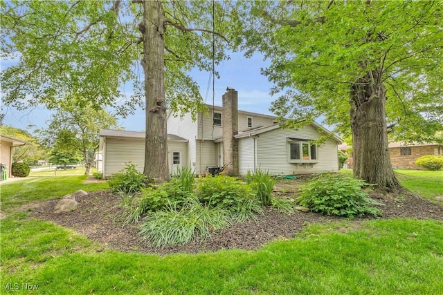 868 King George Blvd, South Euclid, OH 44121 - back of house featuring a chimney and a yard