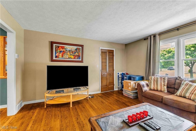 868 King George Blvd, South Euclid, OH 44121 - living area featuring wood finished floors, a textured ceiling, and baseboards