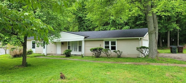 445 Houghton Rd, Sagamore Hills, OH 44067 - view of front of property with a front lawn, an attached garage, asphalt driveway, and a shingled roof