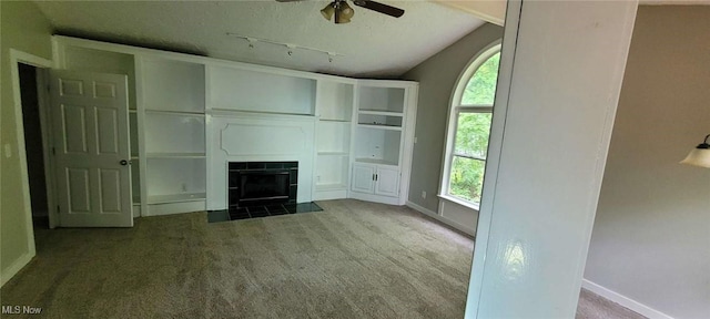 445 Houghton Rd, Sagamore Hills, OH 44067 - unfurnished living room with carpet, track lighting, ceiling fan, baseboards, and a tiled fireplace