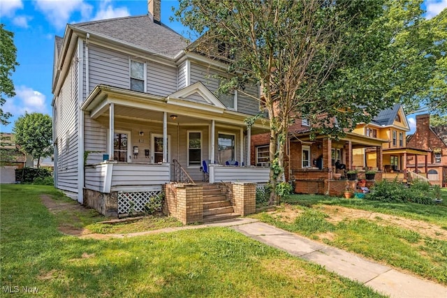 832 Wellman Ave SE, Massillon, OH 44646 - view of front of property with a porch, a front lawn, a chimney, and stairway