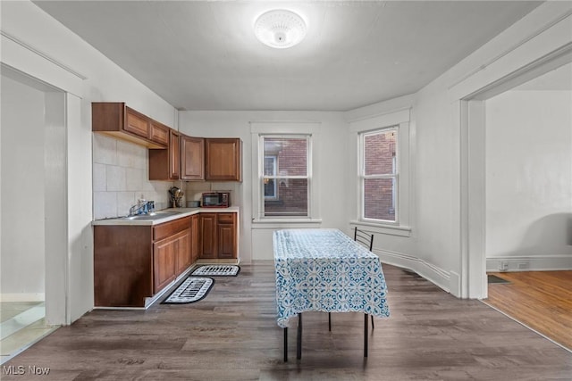 832 Wellman Ave SE, Massillon, OH 44646 - kitchen with dark wood finished floors, light countertops, and brown cabinetry