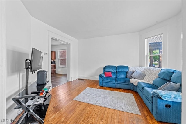 832 Wellman Ave SE, Massillon, OH 44646 - living area featuring plenty of natural light, wood finished floors, and baseboards