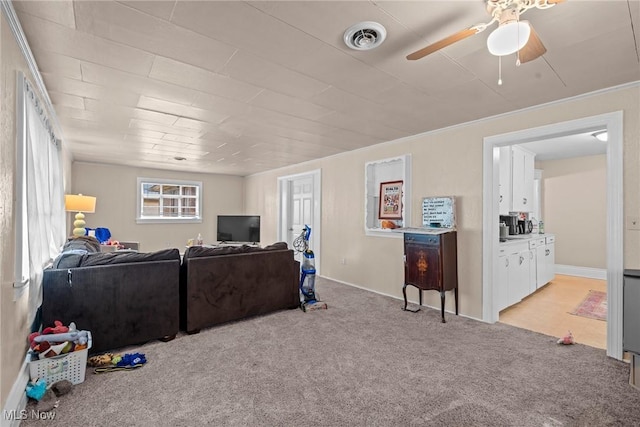 832 Wellman Ave SE, Massillon, OH 44646 - living area with light carpet, ceiling fan, and baseboards