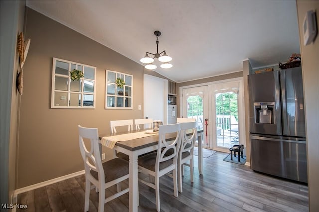 5725 Joleda Dr SW, Canton, OH 44706 - dining area featuring vaulted ceiling, french doors, wood finished floors, a chandelier, and baseboards