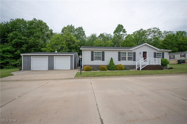 5725 Joleda Dr SW, Canton, OH 44706 - view of front of home with an outbuilding, a detached garage, view of scattered trees, and a front yard