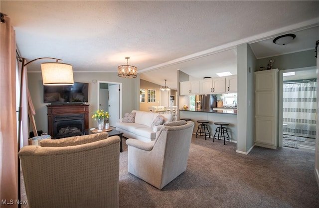 5725 Joleda Dr SW, Canton, OH 44706 - living room with a chandelier, a glass covered fireplace, dark carpet, vaulted ceiling, and baseboards