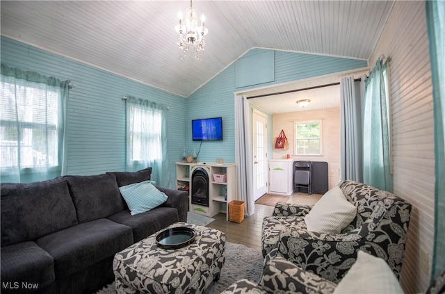 5725 Joleda Dr SW, Canton, OH 44706 - living room with vaulted ceiling, wood finished floors, plenty of natural light, and a chandelier