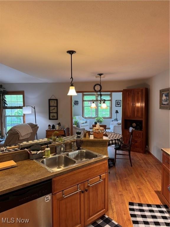 617 Wedgewood Way Unit 617, Millersburg, OH 44654 - kitchen with stainless steel dishwasher, a sink, open floor plan, and light wood finished floors