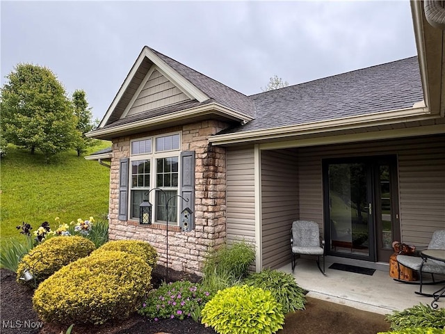 617 Wedgewood Way Unit 617, Millersburg, OH 44654 - doorway to property with stone siding, a shingled roof, and a patio area