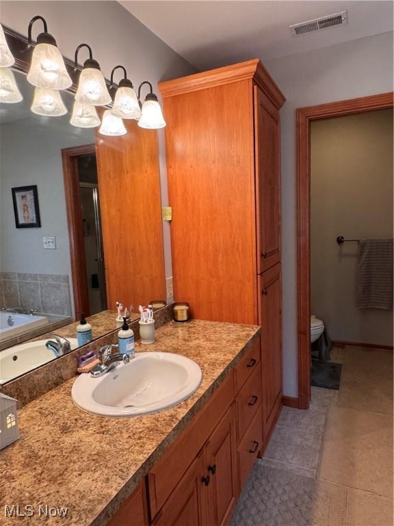 617 Wedgewood Way Unit 617, Millersburg, OH 44654 - bathroom featuring vanity, a garden tub, a shower stall, toilet, and tile patterned flooring