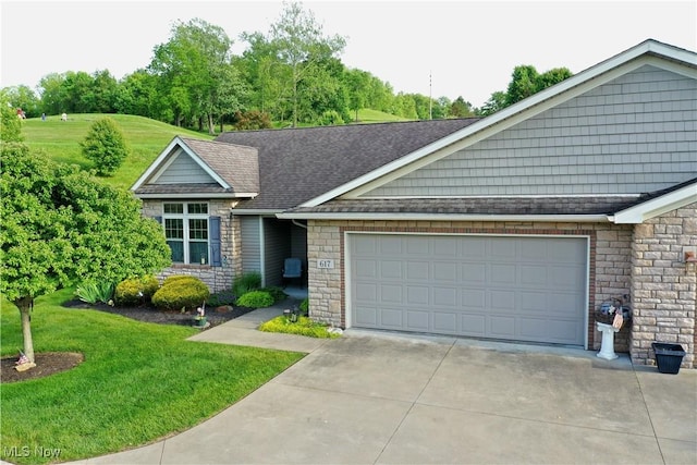 617 Wedgewood Way Unit 617, Millersburg, OH 44654 - view of front of property featuring concrete driveway, stone siding, a garage, and a front lawn