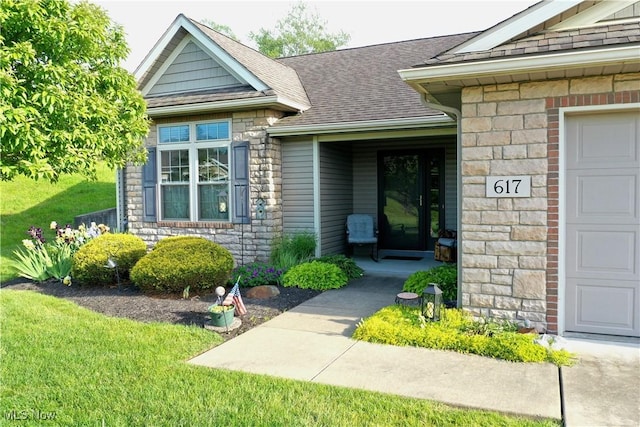617 Wedgewood Way Unit 617, Millersburg, OH 44654 - doorway to property featuring a garage, stone siding, a shingled roof, and a yard