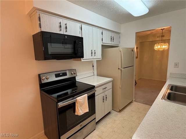 1931 King James Unit 131, Westlake, OH 44145 - kitchen featuring electric stove, black microwave, light countertops, freestanding refrigerator, and light floors