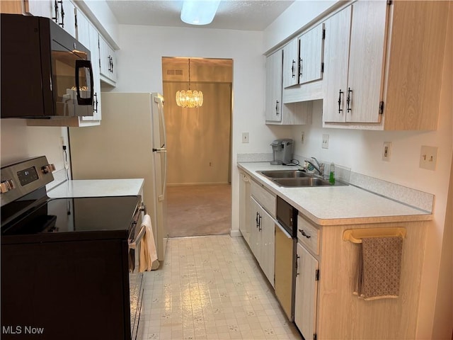 1931 King James Unit 131, Westlake, OH 44145 - kitchen with stainless steel range with electric cooktop, a sink, black microwave, light countertops, and light carpet