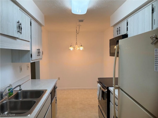 1931 King James Unit 131, Westlake, OH 44145 - kitchen featuring freestanding refrigerator, stainless steel range with electric cooktop, a sink, light floors, and baseboards