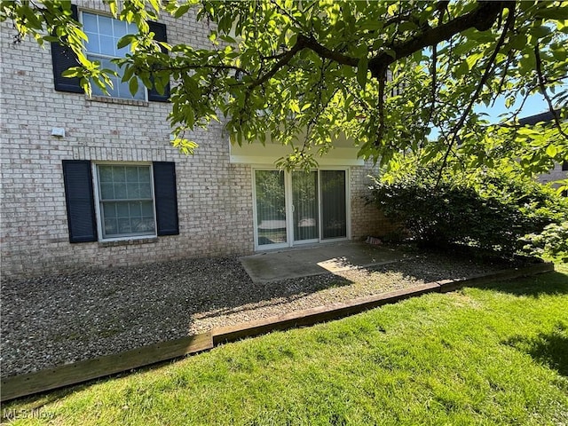 1931 King James Unit 131, Westlake, OH 44145 - back of house featuring brick siding, a yard, and a patio area